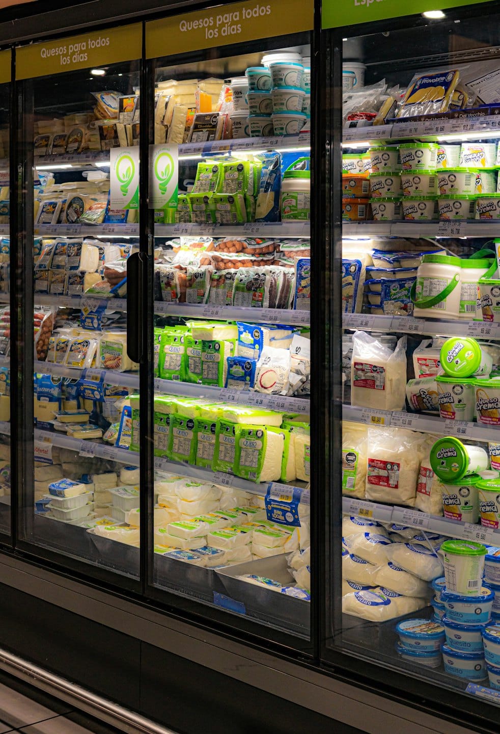 Dairy products arranged neatly on shelves inside a refrigerated grocery case.