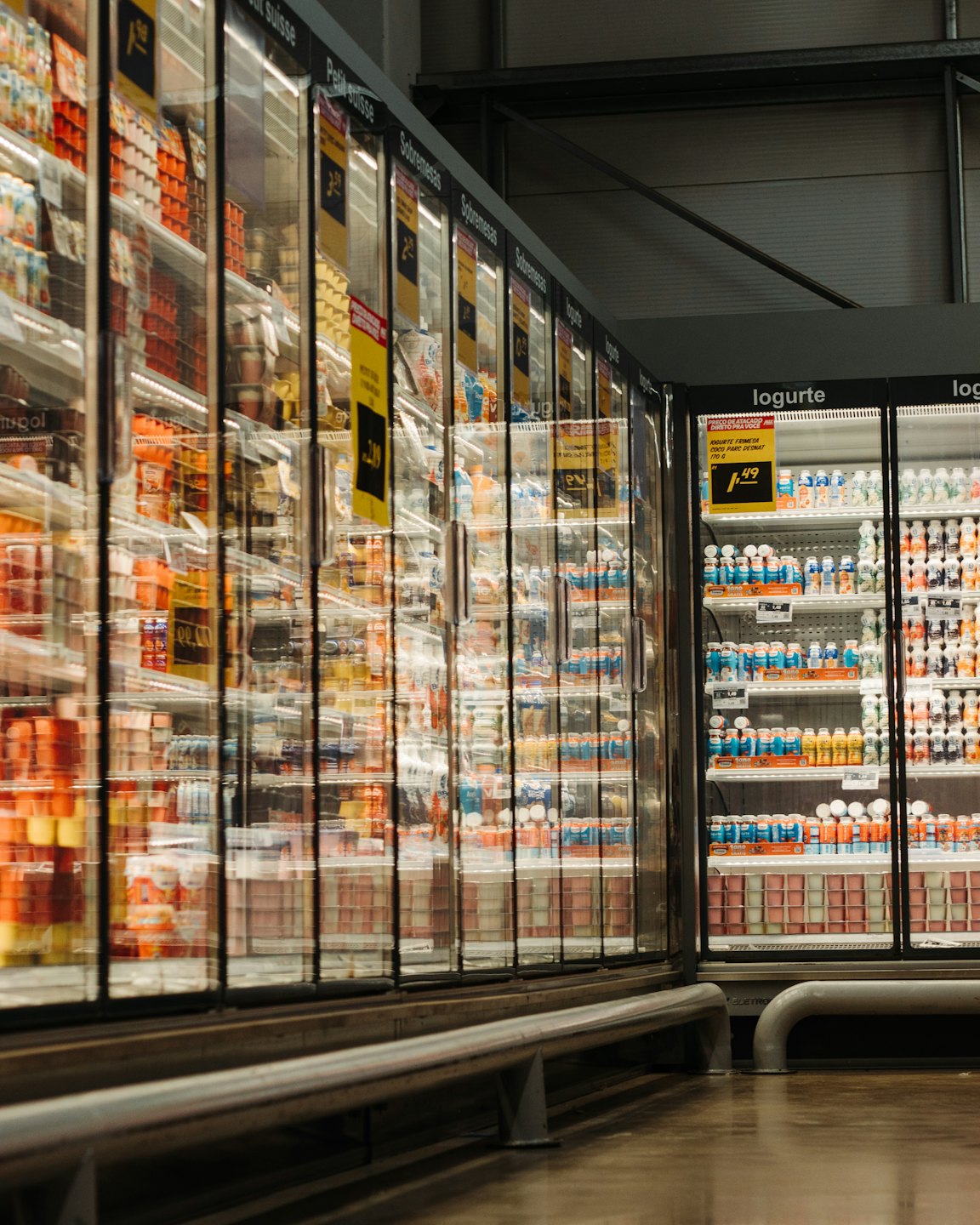 Supermarket aisle filled with dairy products and juices.