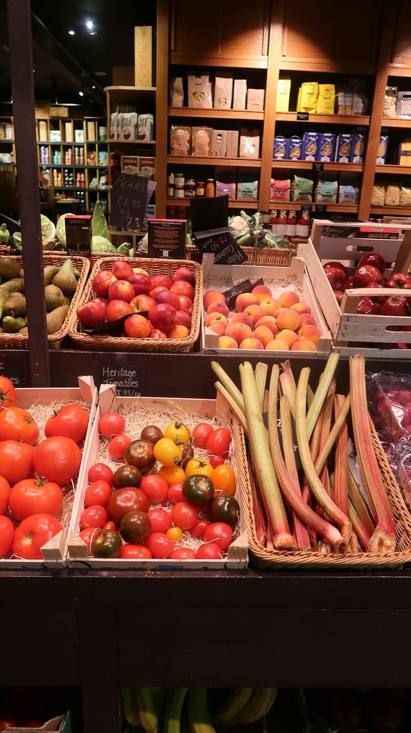 Fresh fruits and vegetables displayed in baskets and crates.